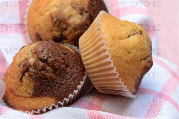 Chocolate muffins in kitchen towel