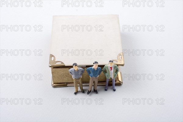 Tiny figurine of men models found beside a book