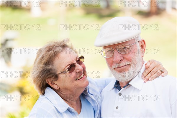 Happy senior couple portrait outside in park