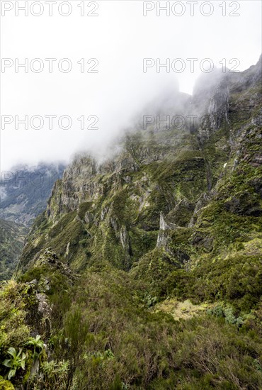 Steep cloudy mountain landscape with rock formations