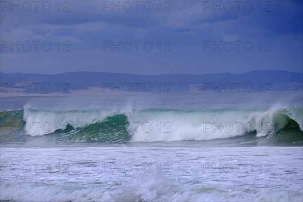 Waves on the beach with dark sky