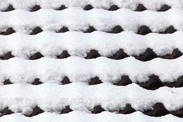 Snowy roof tiles on a roof in winter