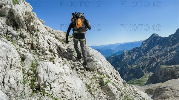 Tourist with equipment on the via ferrata trail in the alps. Zugspitze massif