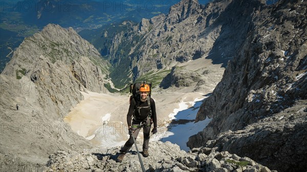 Tourist with equipment on the via ferrata trail in the alps. Zugspitze massif