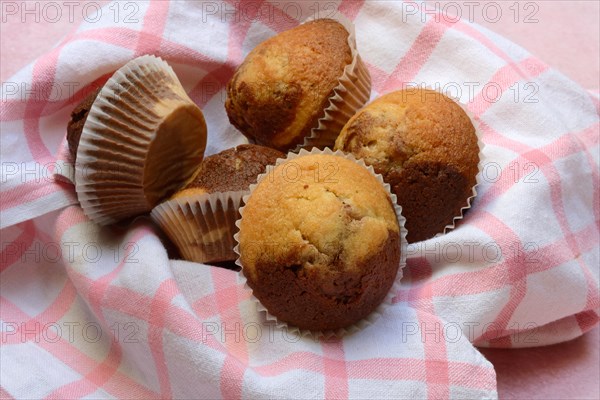 Chocolate muffins in kitchen towel