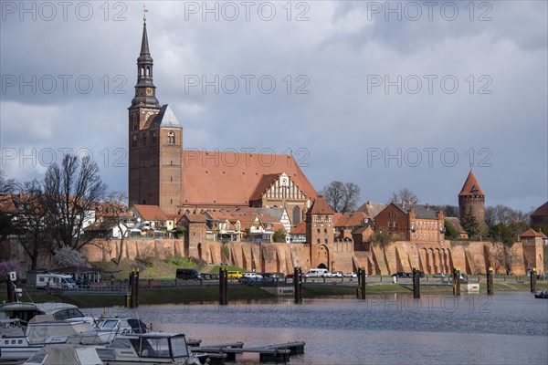 Historic town wall with defence defence tower and St. Stephens Church