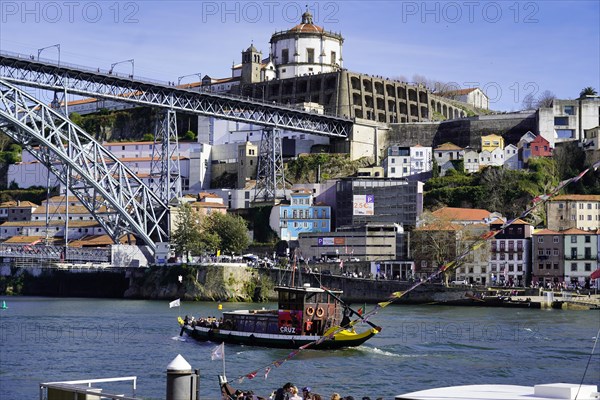 View of the Dom Luis I bridge over Douro River and terracota rooftops