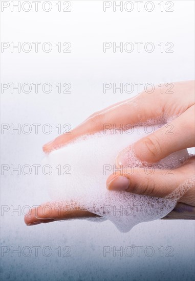 Hand washing and soap foam on a foamy background