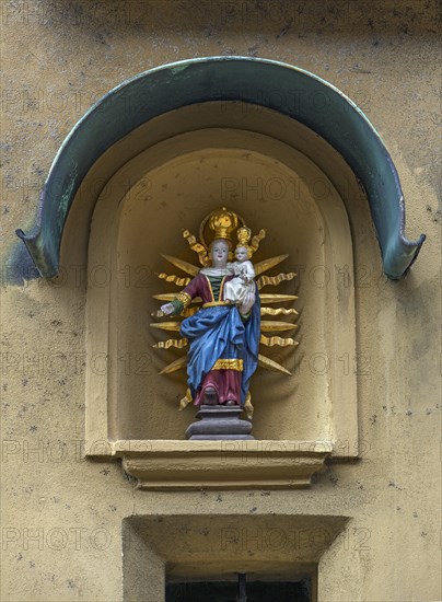 Sculpture of Mary with the Child Jesus in a niche on a residential house