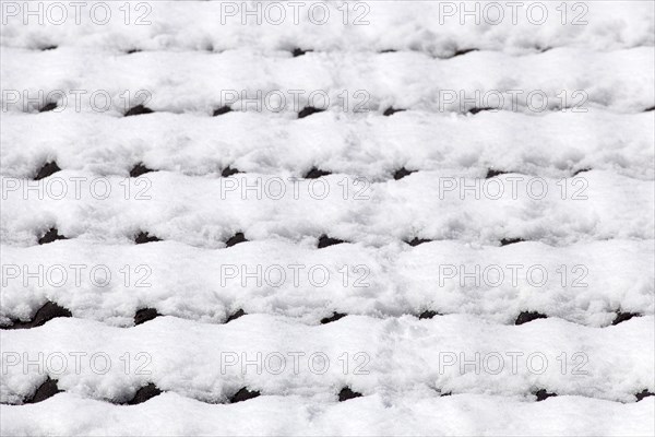 Snowy roof tiles on a roof in winter