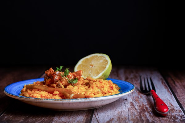 Plate of paella with ribs and green beans