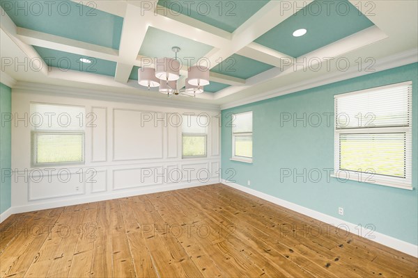 Beautiful light blue custom master bedroom complete with entire wainscoting wall