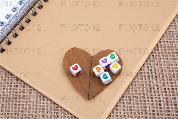 Colorful cubes with a heart on notebook on canvas