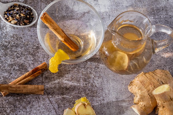 Top view of jar of fresh ginger tea with lemon and cinnamon