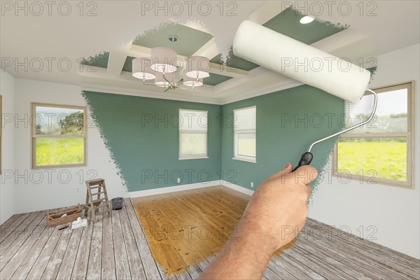 Before and after of man using A paint roller to reveal newly remodeled room with fresh muted teal paint