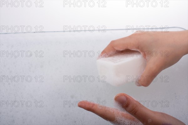 Hand washing and soap foam on a foamy background