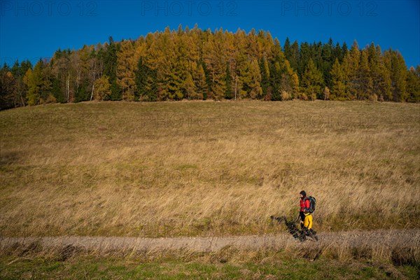 Mum and child are walking along the mountain hiking trail. Family spending time. Polish mountains