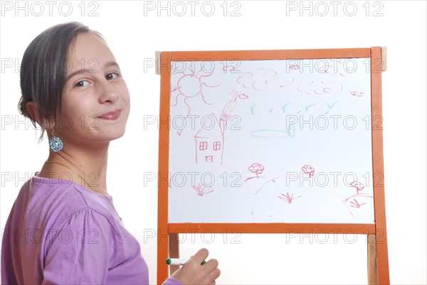 Young girl drawing on the white board