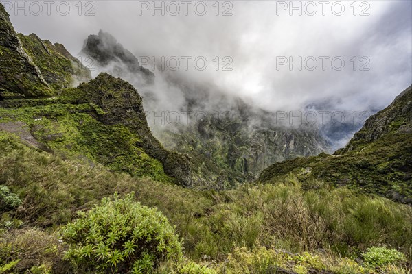 Steep cloudy mountain landscape with rock formations