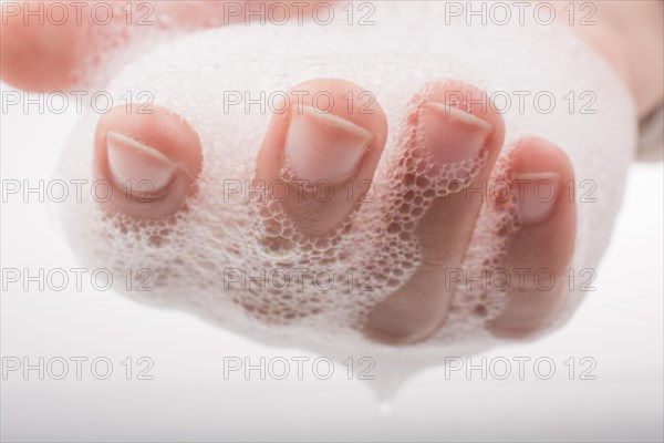 Hand washing and soap foam on a foamy background