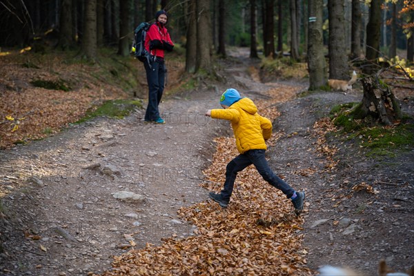 Mum and child are walking along the mountain hiking trail. Family spending time. Polish mountains