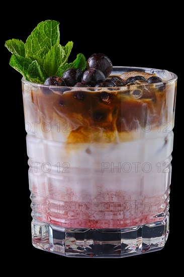 Summer refreshing black currant and cocoa milk cold cocktail isolated on black