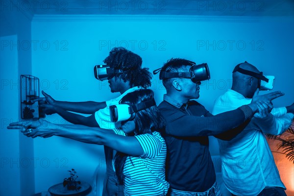 Group of young people with vr glasses in a virtual reality game in a blue light