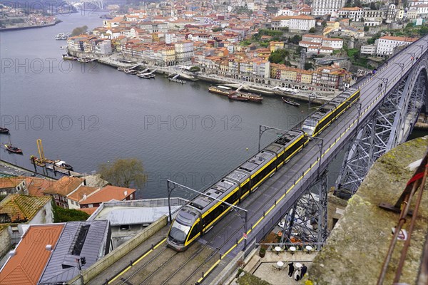 View of the Dom Luis I bridge over Douro River and terracota rooftops