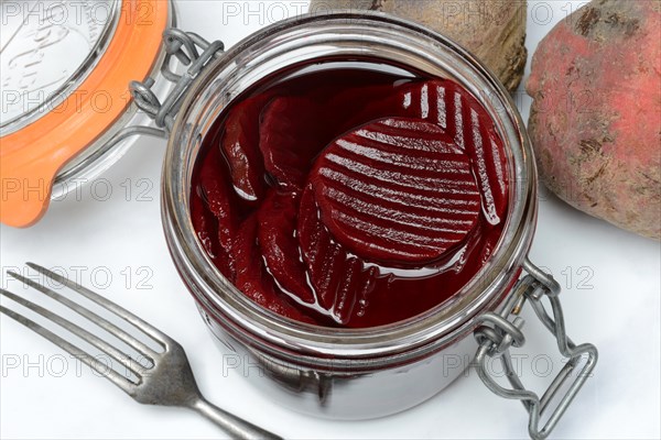 Pickled beetroot in glass jar and beetroot