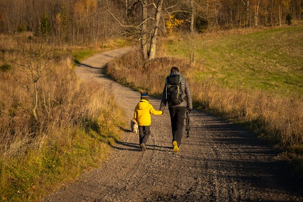 Mum and child are walking along the mountain hiking trail. Family spending time. Polish mountains