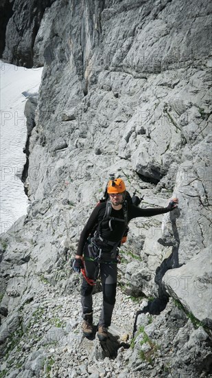 Tourist with equipment on the via ferrata trail in the alps. Zugspitze massif