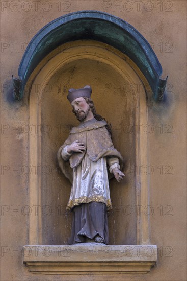 Sculpture of St. Nepomuk in a niche on a residential house