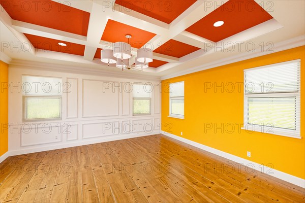 Beautiful bold red and yellow custom master bedroom complete with entire wainscoting wall