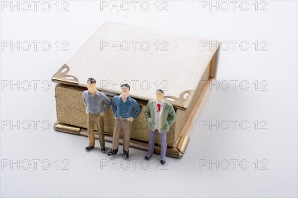 Tiny figurine of men models found beside a book