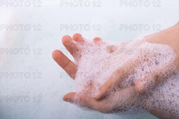 Hand washing and soap foam on a foamy background