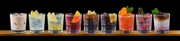 Set of multicolored summer refreshing soft drinks on black background