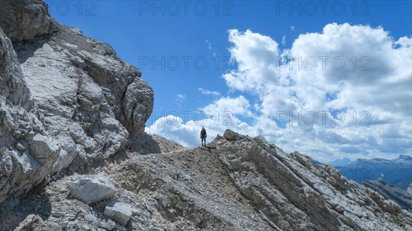 Tourist with equipment on the via ferrata trail in the Dolomites. Dolomites