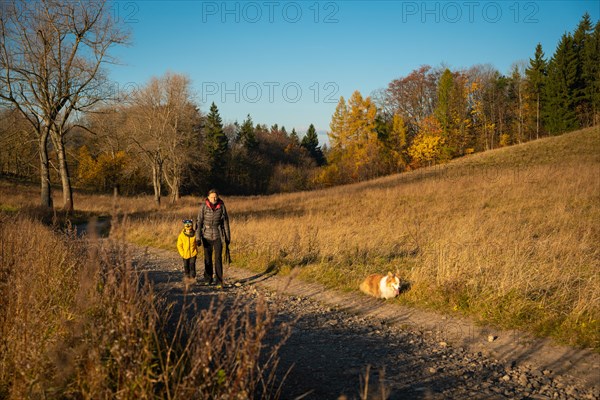 Mum and child are walking along the mountain hiking trail. Family spending time. Polish mountains