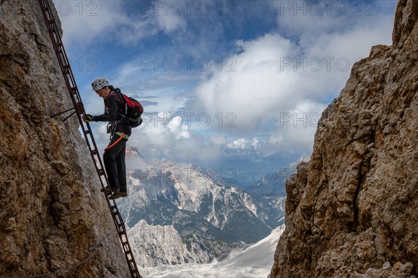 The tutor stands on a rake with a beautiful view in the background of the Alpine Dolomites. Dolomites