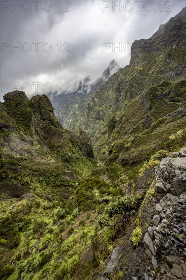 Steep cloudy mountain landscape with rock formations