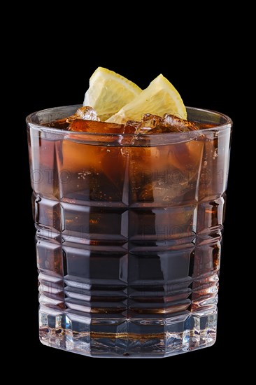 Glass of refreshing cold cola with ice isolated on black
