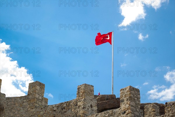 Turkish national flag on a pole on a fortress