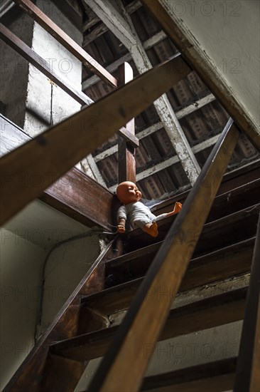 Attic with doll on stairs