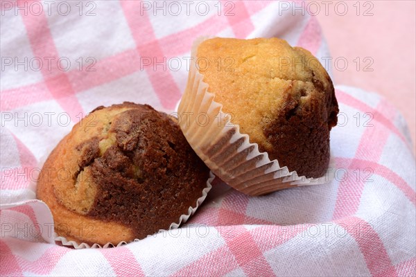 Chocolate muffins in kitchen towel