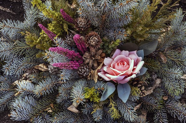 Grave decoration with artificial rose and fir branches