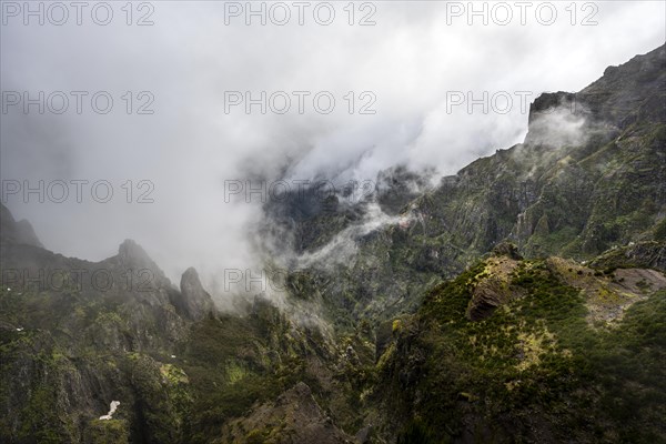 Steep cloudy mountain landscape with rock formations