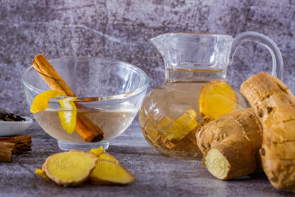 Jar of fresh ginger tea with lemon and cinnamon