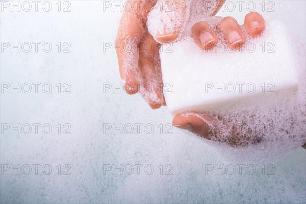 Hand washing and soap foam on a foamy background