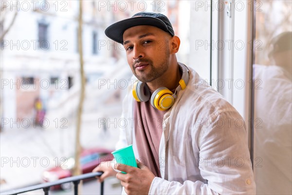 Portrait of a young man of Latino ethnicity on a balcony at home