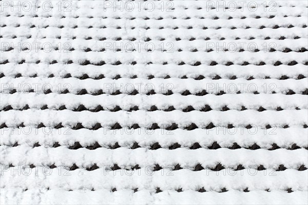 Snowy roof tiles on a roof in winter